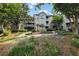 Beautiful condo exterior with landscaped grounds and a charming pergola feature at 1250 Parkwood Circle Se # 1110, Atlanta, GA 30339