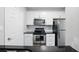Modern kitchen with stainless steel appliances, white cabinets, and dark countertops at 1250 Parkwood Circle Se # 1110, Atlanta, GA 30339