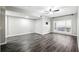 Comfortable living room featuring modern ceiling fan, large window, and updated flooring at 1250 Parkwood Circle Se # 1110, Atlanta, GA 30339