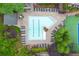 Aerial view of a stunning pool surrounded by lush landscaping and lounge chairs at 1250 Parkwood Circle Se # 1110, Atlanta, GA 30339
