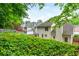 Backyard view showcasing the home's exterior, surrounding greenery, and proximity to neighboring houses at 2918 Arbor Creek Ln, Atlanta, GA 30340