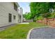 Well-maintained backyard with lush green lawn, stone retaining wall, and patio area, perfect for outdoor enjoyment at 2918 Arbor Creek Ln, Atlanta, GA 30340