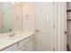 Bright bathroom features a white vanity, white walls, and a framed mirror at 2918 Arbor Creek Ln, Atlanta, GA 30340