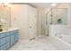 Bright bathroom featuring a tub, shower with glass enclosure, and double vanity at 2918 Arbor Creek Ln, Atlanta, GA 30340