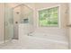 Bathroom with a garden tub, shower with glass enclosure, and a window for natural light at 2918 Arbor Creek Ln, Atlanta, GA 30340