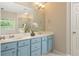 Bright bathroom featuring double vanity, updated fixtures, marble floors, and natural light at 2918 Arbor Creek Ln, Atlanta, GA 30340