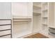 Custom walk-in closet with shelving and drawers and wood floor at 2918 Arbor Creek Ln, Atlanta, GA 30340