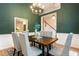 Sophisticated dining room with green walls and a modern chandelier over a wooden table at 2918 Arbor Creek Ln, Atlanta, GA 30340