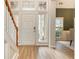 Welcoming foyer with natural light, showcasing staircase and wainscoting at 2918 Arbor Creek Ln, Atlanta, GA 30340