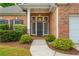 Inviting front entrance with brick facade, manicured landscaping, and covered porch at 2918 Arbor Creek Ln, Atlanta, GA 30340
