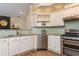 Modern kitchen with stainless steel appliances, granite countertops, and light green backsplash at 2918 Arbor Creek Ln, Atlanta, GA 30340
