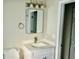 Bathroom with white vanity, modern fixtures, decorative mirror, and access to walk-in closet at 2961 Stone Mountain St, Lithonia, GA 30058