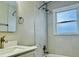 Modern bathroom featuring new tiles, a updated vanity, and shower with sleek hardware at 2961 Stone Mountain St, Lithonia, GA 30058