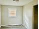 Bedroom featuring wood-look flooring, a window with blinds, and closet with shelves at 2961 Stone Mountain St, Lithonia, GA 30058
