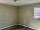 Cozy bedroom with wood-look flooring and a large window providing natural light at 2961 Stone Mountain St, Lithonia, GA 30058