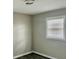 Bedroom featuring wood-look flooring, a window with blinds, and a modern ceiling light at 2961 Stone Mountain St, Lithonia, GA 30058