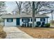 Charming single-story home with white siding, black shutters, and a well-manicured front yard at 2961 Stone Mountain St, Lithonia, GA 30058
