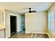 Inviting living room with wood-look flooring, a modern ceiling fan, and ample natural light at 2961 Stone Mountain St, Lithonia, GA 30058