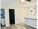 Bright living room featuring wood-look floors, modern light fixtures, and open access to the kitchen at 2961 Stone Mountain St, Lithonia, GA 30058