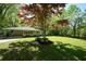Quaint home with a lush green lawn and mature trees at 343 Ridge Pine Dr, Canton, GA 30114