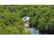 Aerial view of the property showcases a swimming pool, tennis courts, and lush greenery at 3563 Castleridge Dr, Tucker, GA 30084