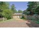 Wide backyard showcasing a spacious grassy area, a fenced area, and a home's rear entrance at 3563 Castleridge Dr, Tucker, GA 30084