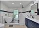 Modern bathroom features a freestanding tub, rainfall shower, and stylish blue vanity at 3563 Castleridge Dr, Tucker, GA 30084