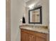 The bathroom includes a wooden vanity with a granite countertop and a decorative framed mirror at 3563 Castleridge Dr, Tucker, GA 30084