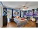 Large bedroom with hardwood floors, ceiling fan, and windows for natural light at 3563 Castleridge Dr, Tucker, GA 30084