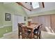 Dining area with a vaulted ceiling, skylight, hardwood table, and seating for eight at 3563 Castleridge Dr, Tucker, GA 30084