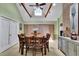 Dining area with a vaulted ceiling, skylight, hardwood table, and seating for eight at 3563 Castleridge Dr, Tucker, GA 30084