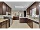 Kitchen with stainless steel appliances, dark brown cabinets, and granite countertops at 3563 Castleridge Dr, Tucker, GA 30084