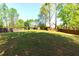 Expansive grassy backyard enclosed by a wooden privacy fence at 4125 Barnes Meadow Sw Rd, Smyrna, GA 30082