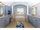 Inviting bathroom with a tub, dual vanity sinks, and plenty of cabinet space at 4125 Barnes Meadow Sw Rd, Smyrna, GA 30082
