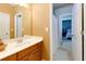 Well-lit bathroom features a vanity with storage, a mirror, and an adjoining room at 4125 Barnes Meadow Sw Rd, Smyrna, GA 30082