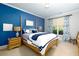 Bedroom featuring a well-lit window, lamps, and blue decor at 4125 Barnes Meadow Sw Rd, Smyrna, GA 30082