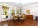 Cozy dining area with access to the outdoors, hardwood floors, and a modern chandelier at 4125 Barnes Meadow Sw Rd, Smyrna, GA 30082