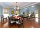 Elegant dining room features hardwood floors and a stylish chandelier with abundant natural light at 4125 Barnes Meadow Sw Rd, Smyrna, GA 30082