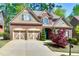 Beautiful two-story brick home with a well-manicured lawn, two-car garage and colorful landscaping at 4125 Barnes Meadow Sw Rd, Smyrna, GA 30082
