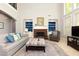 Airy living room with high ceilings, a brick fireplace, and comfortable seating arrangement. Lots of light! at 4125 Barnes Meadow Sw Rd, Smyrna, GA 30082