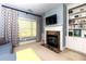 Comfortable living room area with built-in shelving, fireplace, and bright window at 4125 Barnes Meadow Sw Rd, Smyrna, GA 30082