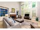 Bright, open living room with a fireplace and large windows offering ample natural light and views at 4125 Barnes Meadow Sw Rd, Smyrna, GA 30082