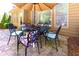Outdoor patio featuring a table with umbrella and iron chairs at 4125 Barnes Meadow Sw Rd, Smyrna, GA 30082