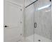 Modern bathroom featuring marble tile shower with glass door and white door at 159 Sunshower Rdg, Canton, GA 30114