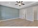 Bright bedroom with trey ceilings, light hardwood floors, and a decorative blue wall at 159 Sunshower Rdg, Canton, GA 30114