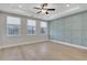 Large bedroom with trey ceilings, a ceiling fan, light hardwood floors, and three large windows at 159 Sunshower Rdg, Canton, GA 30114