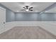 Finished bonus room features large mirror, ceiling fan, carpet flooring and wainscoting at 159 Sunshower Rdg, Canton, GA 30114