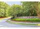 Stone Great Sky entrance wall surrounded by manicured green hedges and mature trees at 159 Sunshower Rdg, Canton, GA 30114