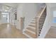 Bright entryway featuring light wood floors, white trim, and a staircase with black iron railings at 159 Sunshower Rdg, Canton, GA 30114
