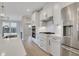 Well-lit kitchen featuring stainless steel appliances, modern white cabinets, and a central island with seating at 159 Sunshower Rdg, Canton, GA 30114